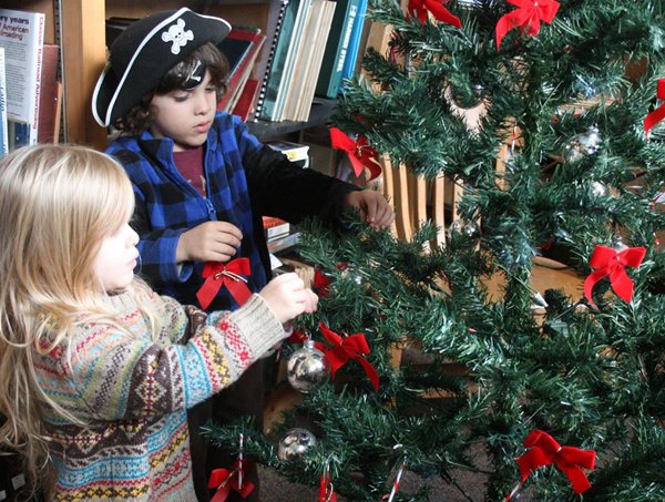 photo of youngsters decorating tree