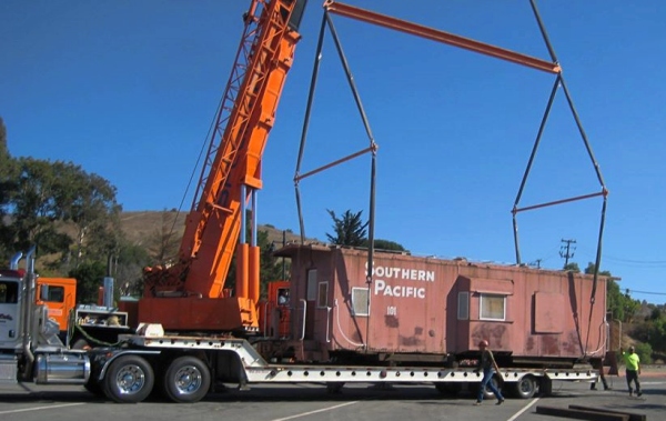 photo of caboose arriving at museum on trailer